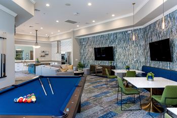 a games room with a pool table and a flat screen tv  at Missions at Sunbow Apartments, Chula Vista, CA, 91911